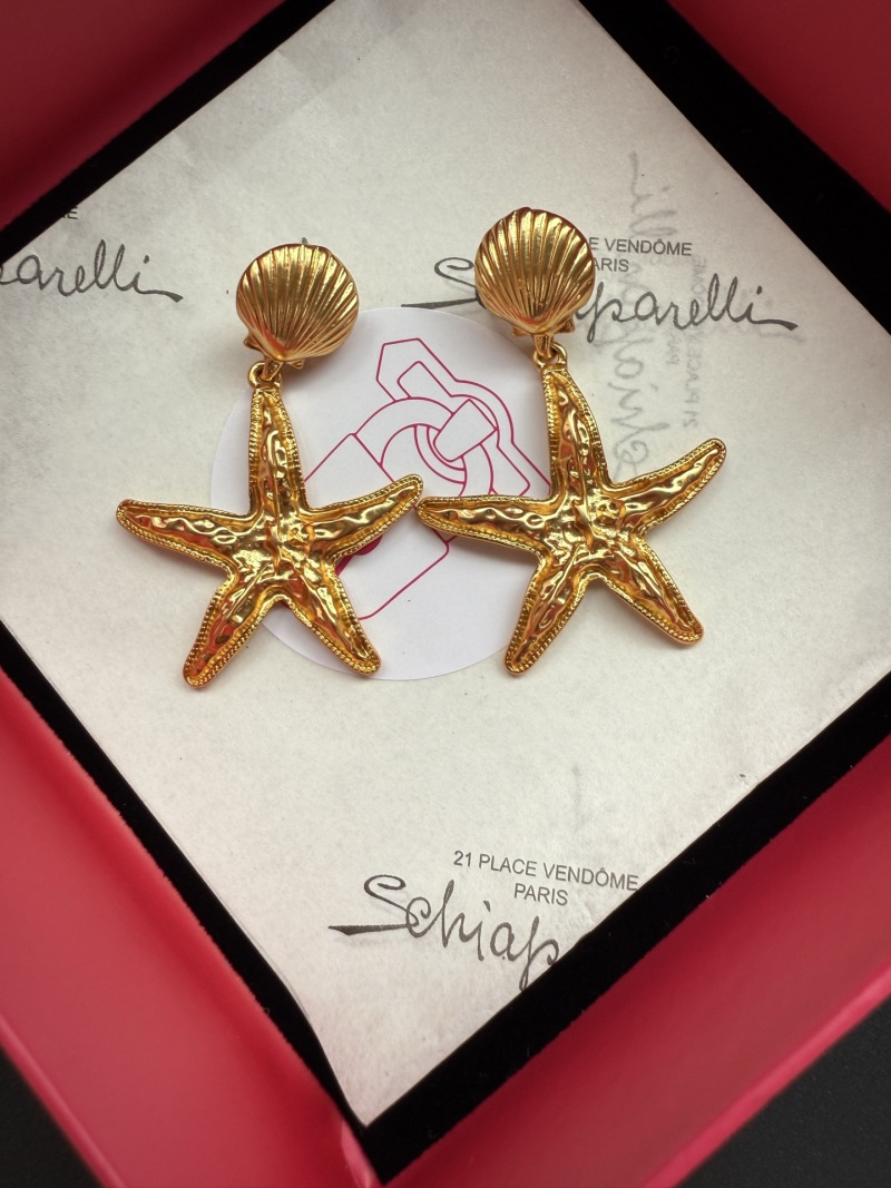 Золотистые серьги в виде звезды Schiaparelli