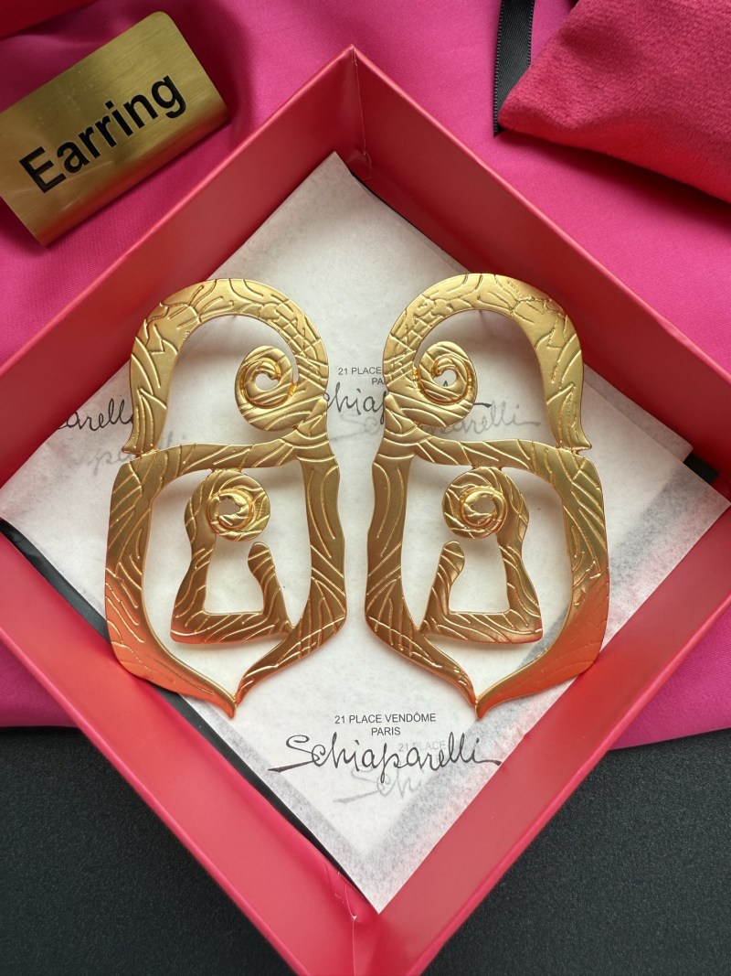 Золотистые серьги Schiaparelli