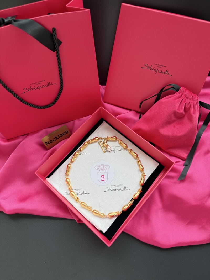 Золотистое колье с гладкими бусинами Schiaparelli