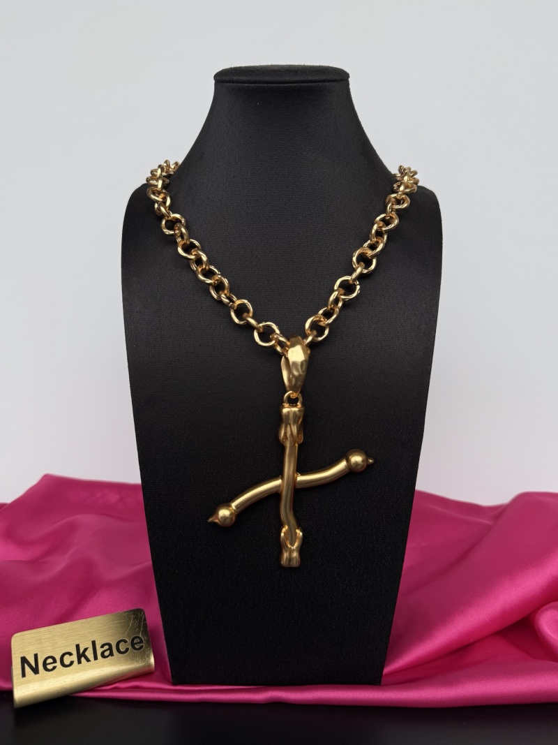 Золотистое колье с крестом Schiaparelli