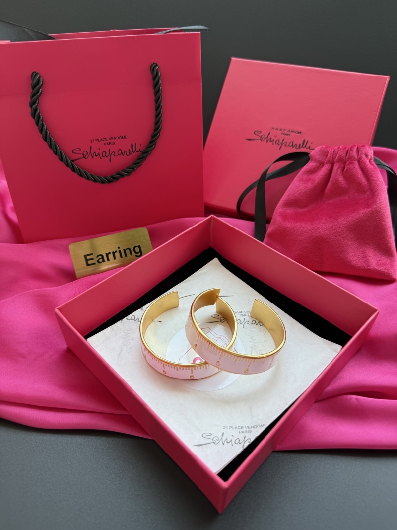 Серьги Schiaparelli с золотой окантовкой и белым измерительным дизайном