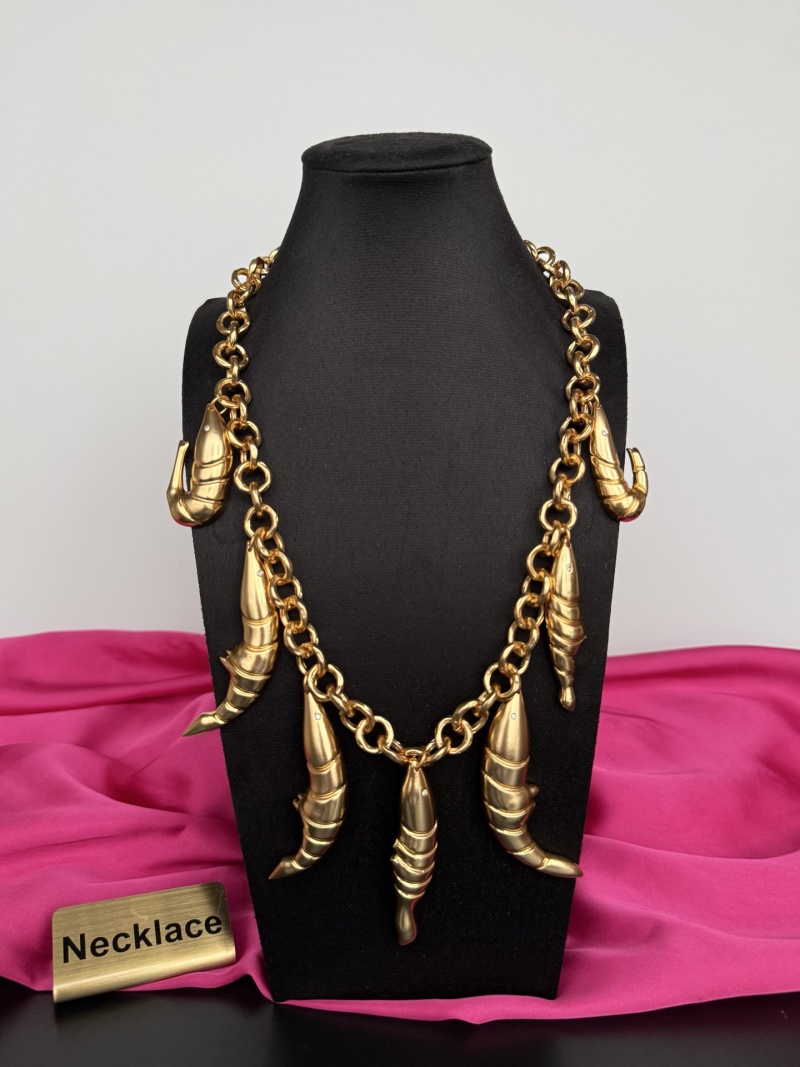 Золотистое колье с декоративными элементами Schiaparelli