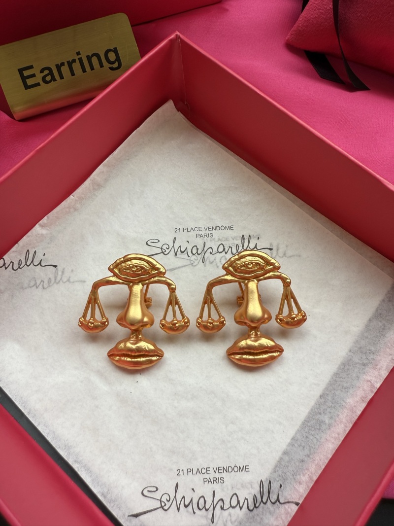 Серьги Schiaparelli с изображением весов и глаза