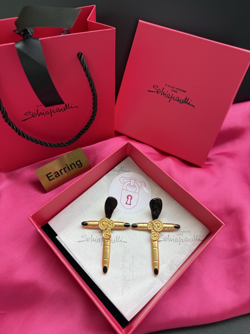 Серьги Schiaparelli в форме креста с золотым покрытием и черными элементами