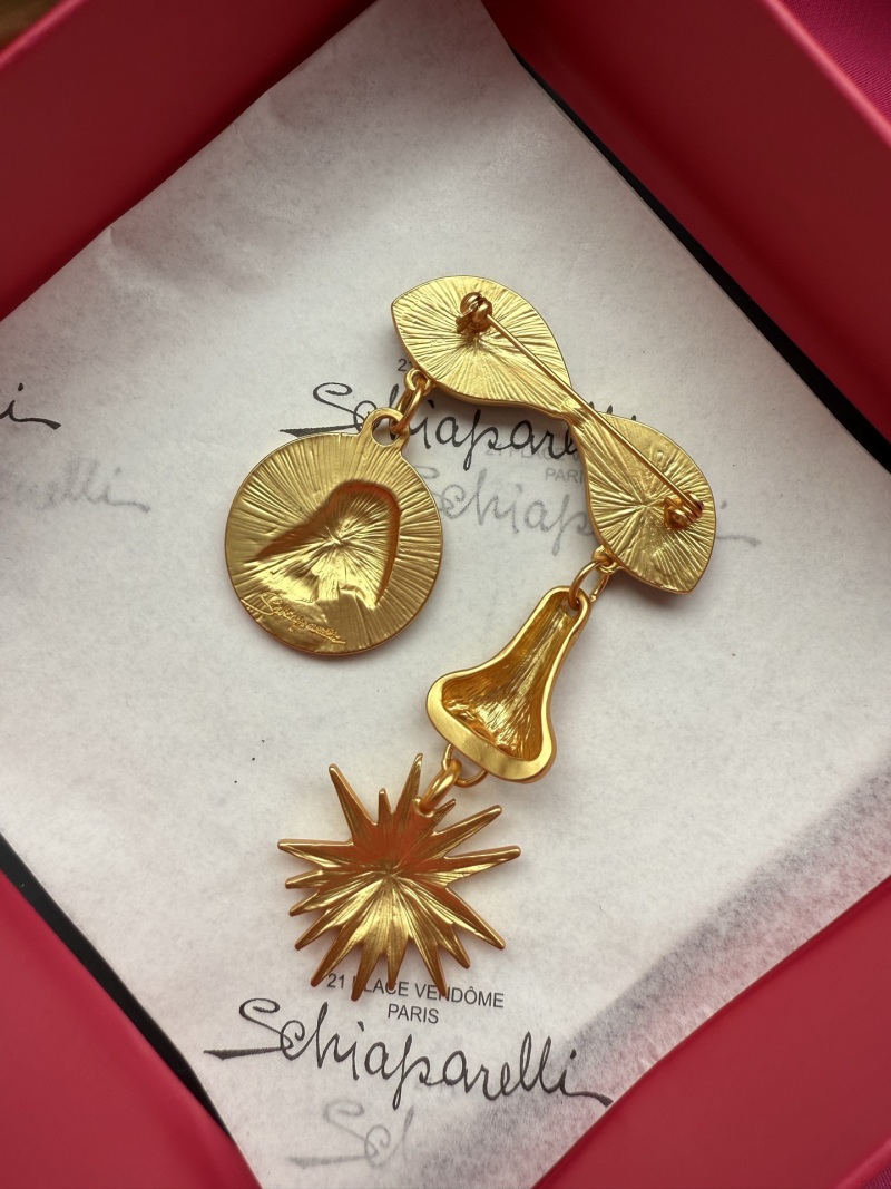 Брошь Schiaparelli с глазами и солнцем