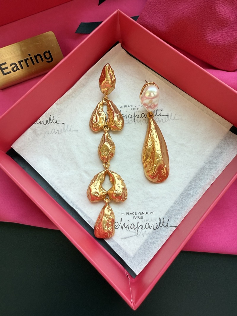 Золотистые серьги Schiaparelli