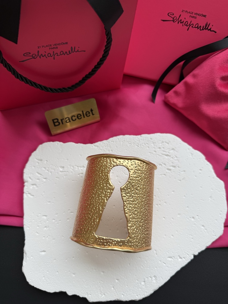 Золотистый браслет с рельефной текстурой и вырезом в виде ключа Schiaparelli