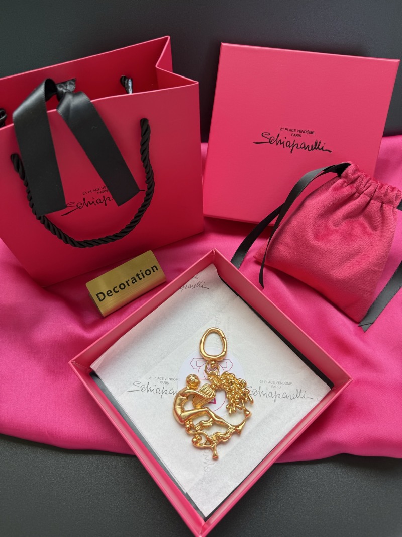 Комплект бижутерии в виде ключницы с символикой зодиака Schiaparelli