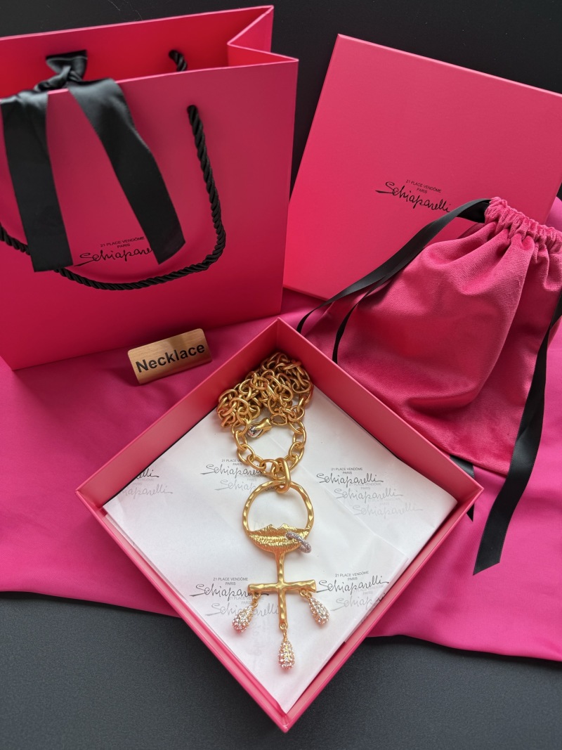 Золотистое колье с подвеской в виде креста и капель Schiaparelli