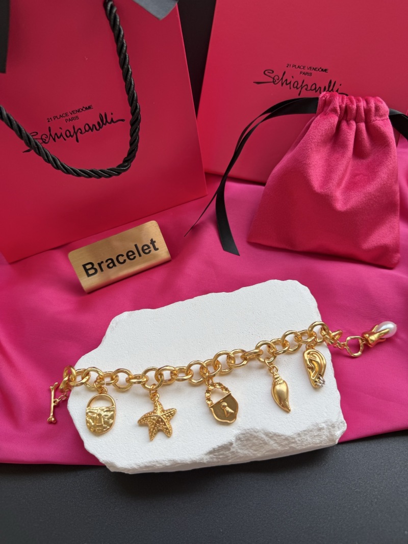 Золотистый браслет с подвесками Schiaparelli