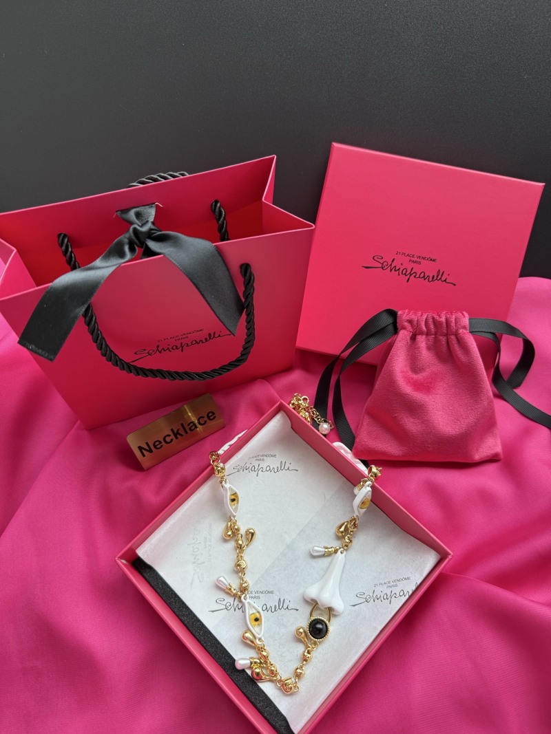 Нарядное колье с белыми и золотыми элементами Schiaparelli