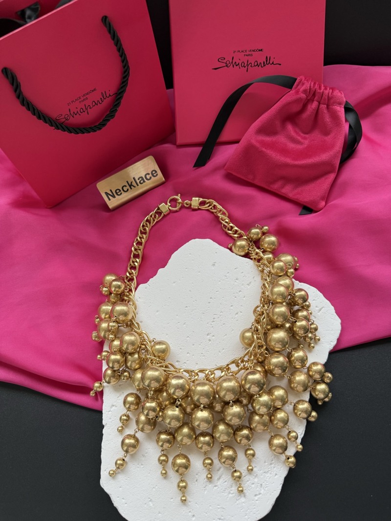 Золотистое колье с подвесками Schiaparelli