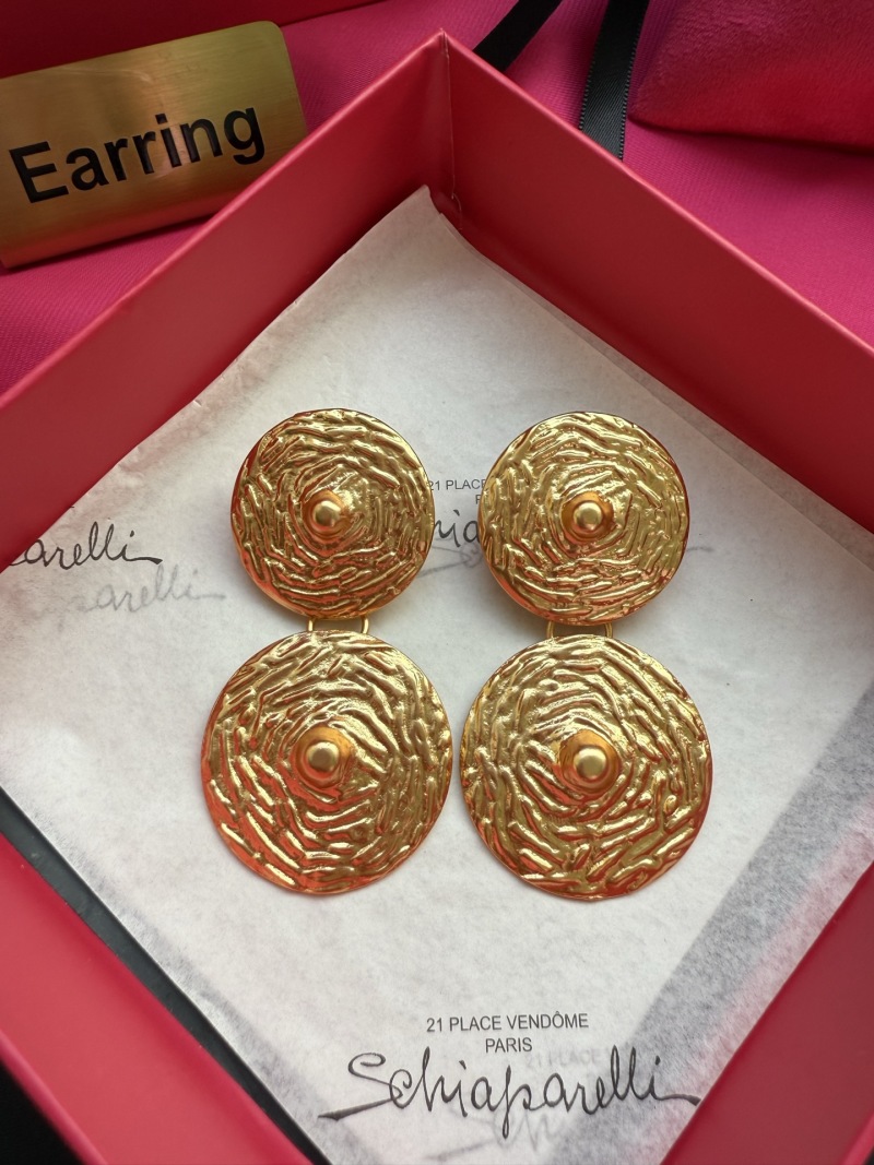 Золотистые серьги Schiaparelli