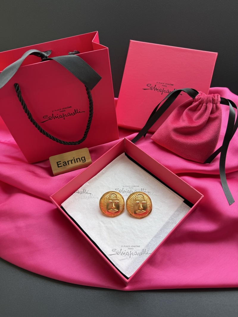 Серьги Schiaparelli с лицом и сумкой