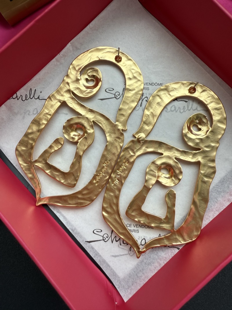Золотистые серьги Schiaparelli