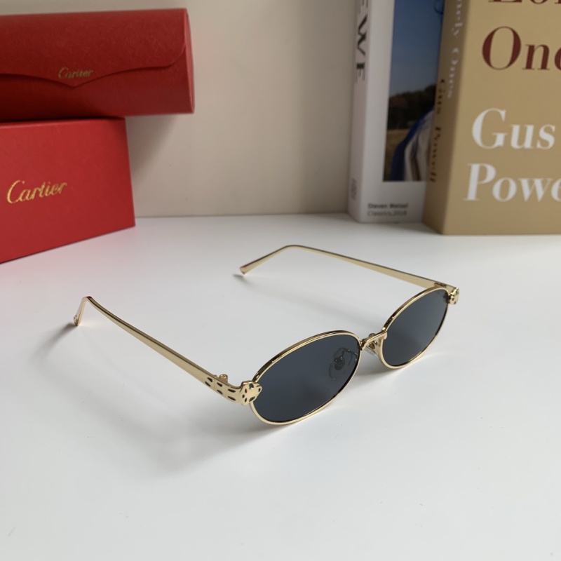 Солнцезащитные очки с овальной золотистой оправой и темными линзами Cartier