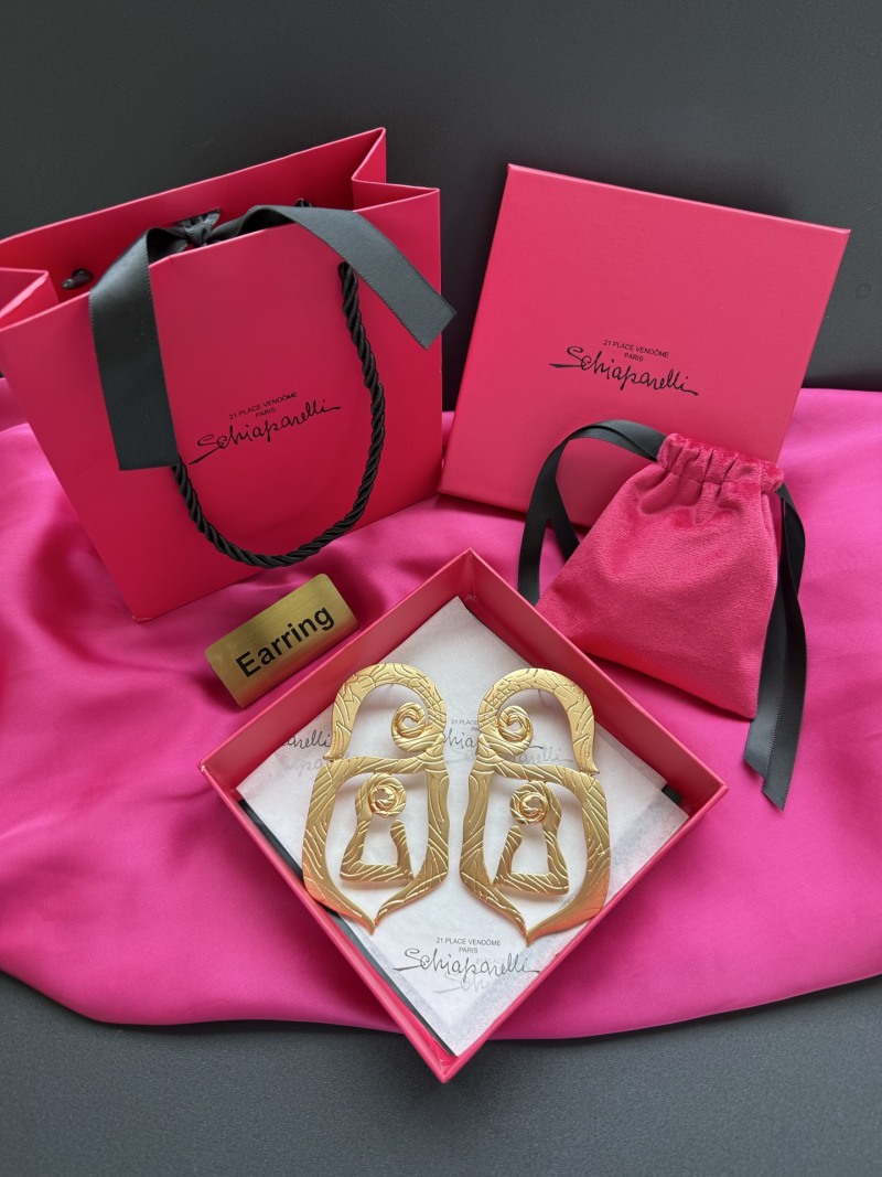 Золотистые серьги Schiaparelli