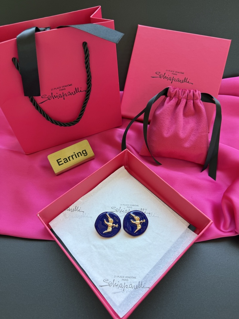 Серьги Schiaparelli с золотым орлом на синем фоне