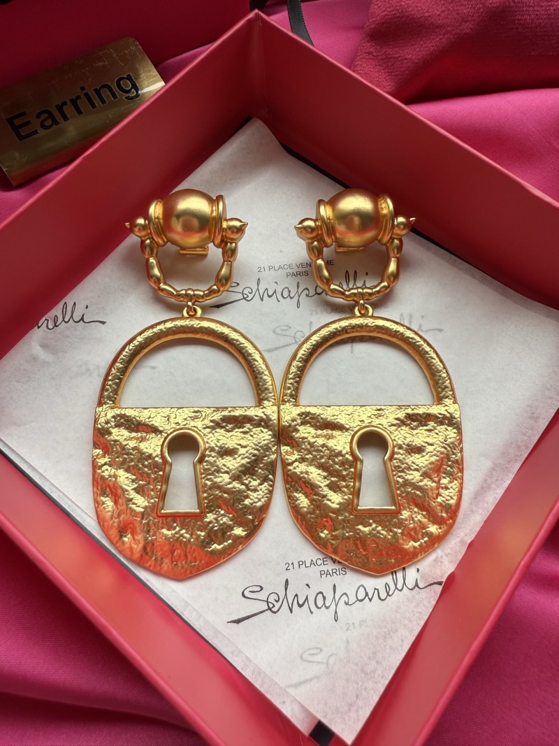 Золотистые серьги в форме замка Schiaparelli