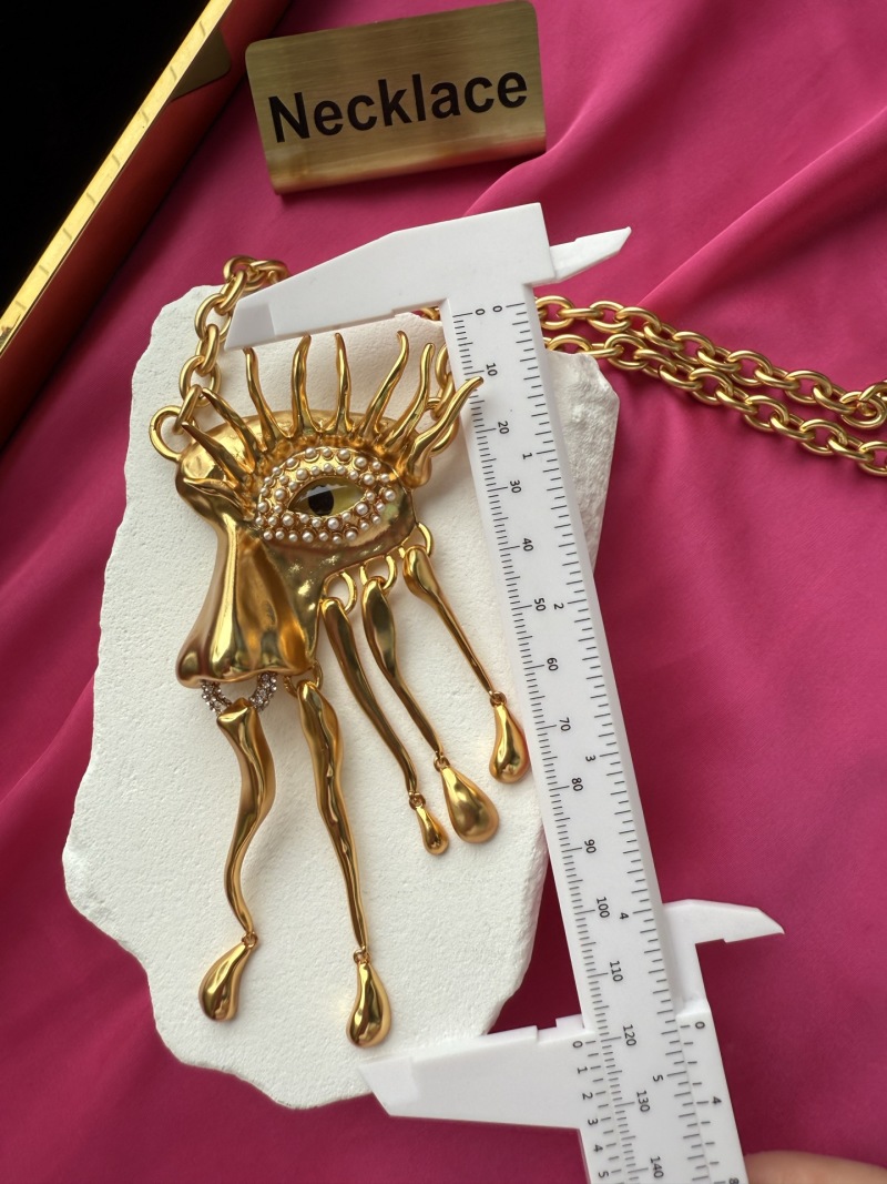 Золотистое колье с глазом и каплями Schiaparelli