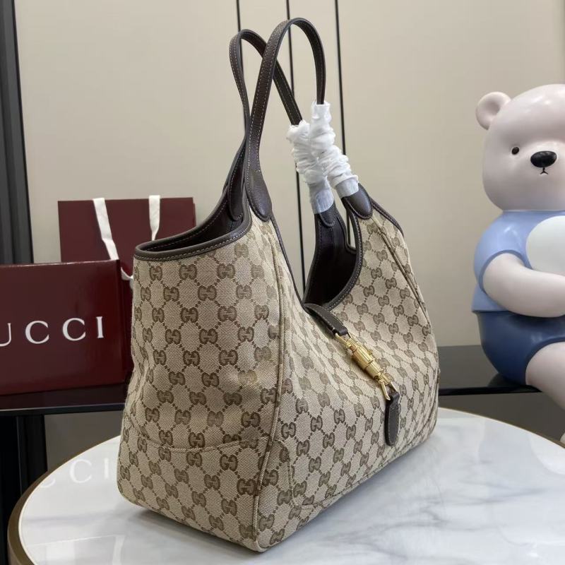 Сумка Gucci с монограммой и кожаной отделкой