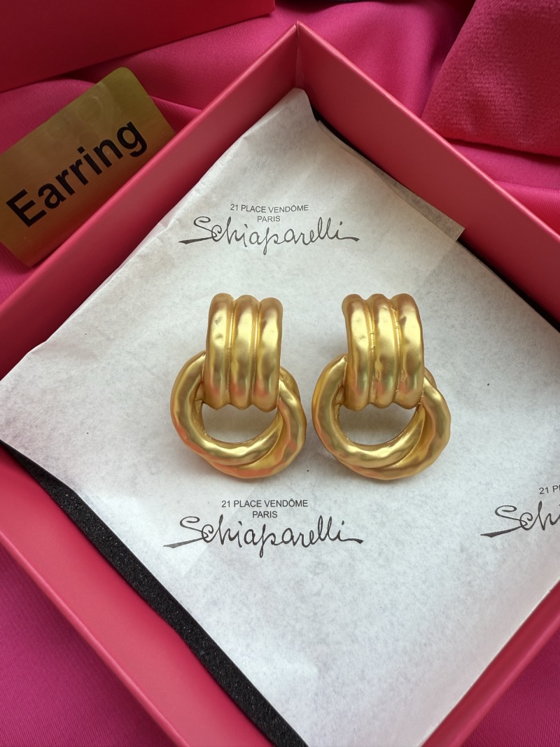 Золотистые серьги с узлом Schiaparelli