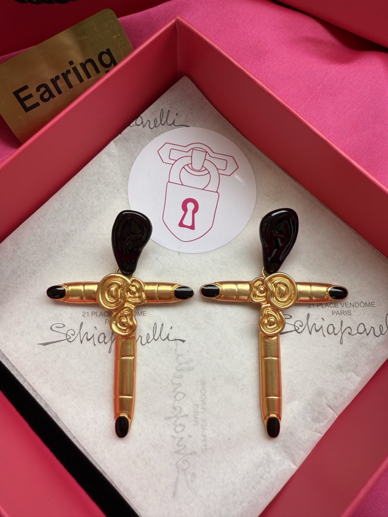 Серьги Schiaparelli в форме креста с золотым покрытием и черными элементами