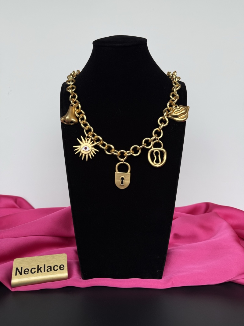 Золотистое колье с декоративными подвесками Schiaparelli
