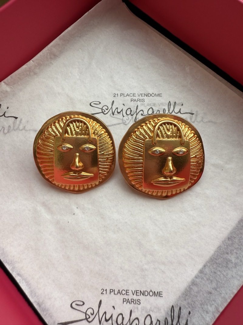 Серьги Schiaparelli с лицом и сумкой