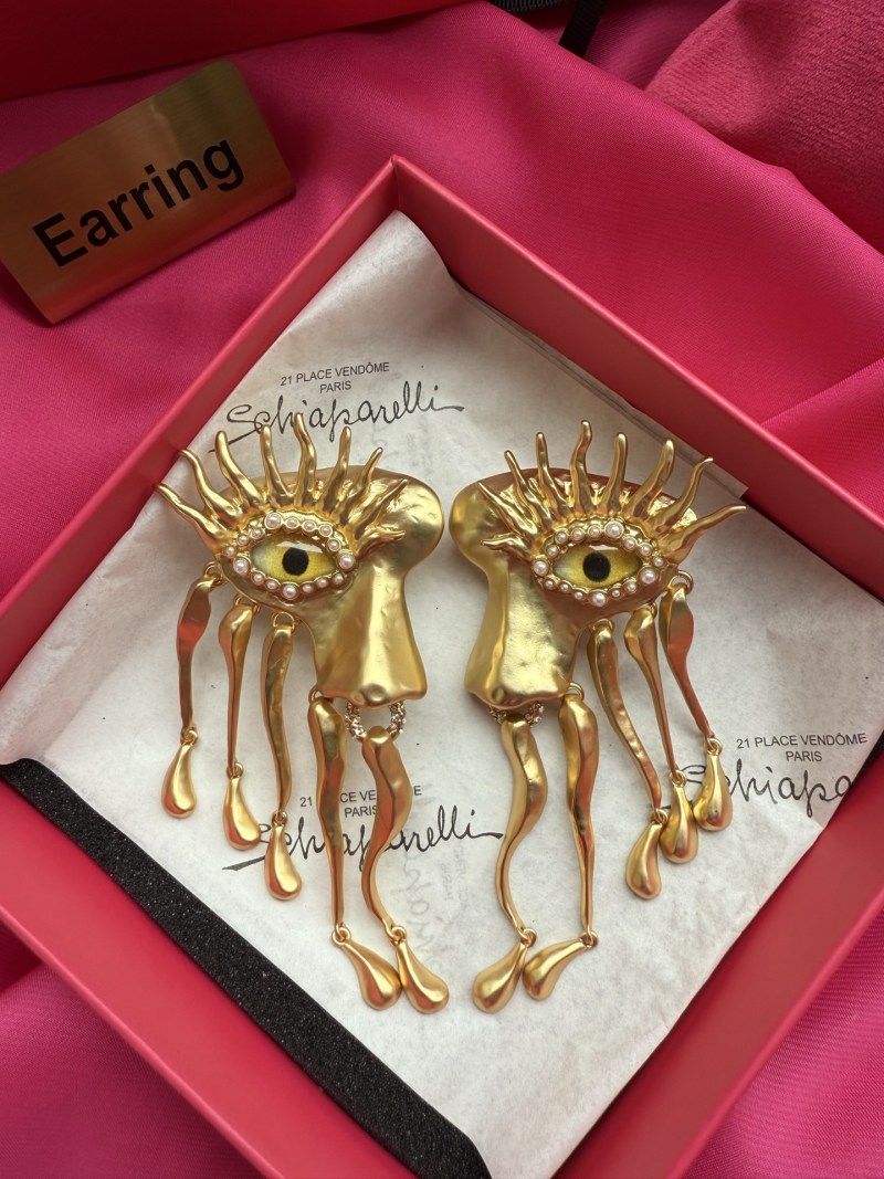 Серьги Schiaparelli с глазами и золотыми деталями