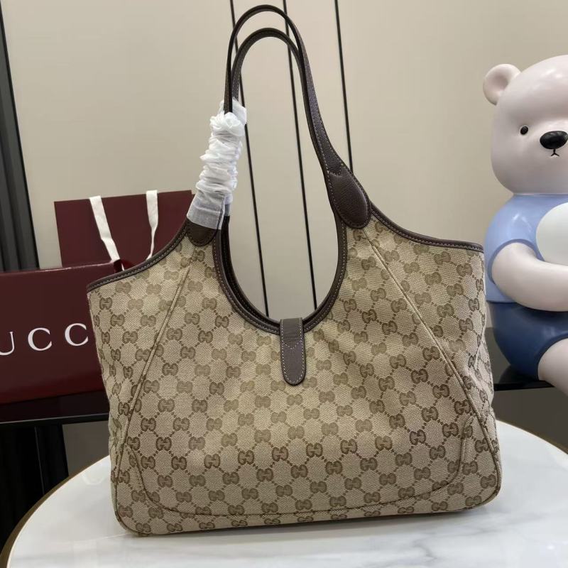 Сумка Gucci с монограммой и кожаной отделкой