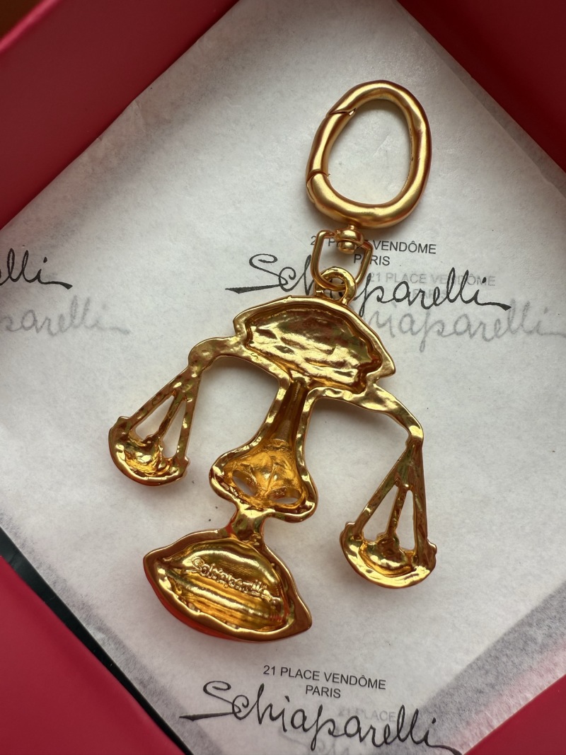 Комплект бижутерии в виде золотых весов Schiaparelli
