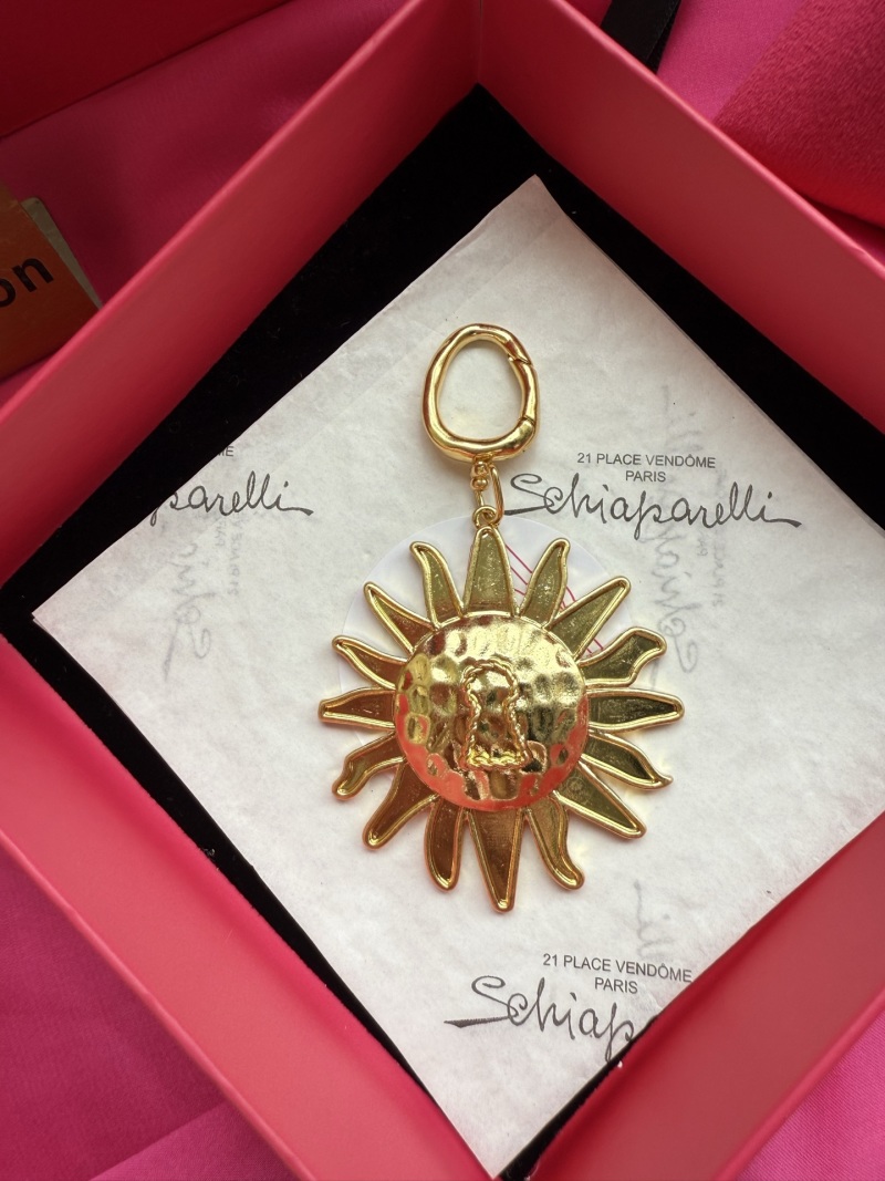 Подвеска в виде солнца с лицом Schiaparelli