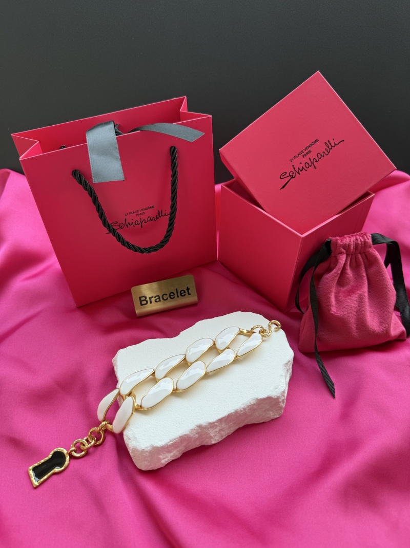 Браслет с белыми элементами и золотистой фурнитурой Schiaparelli