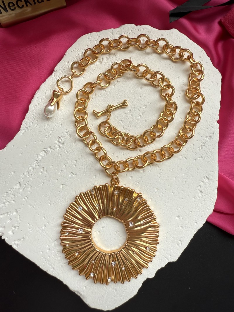 Золотистое колье с декоративным подвесом Schiaparelli