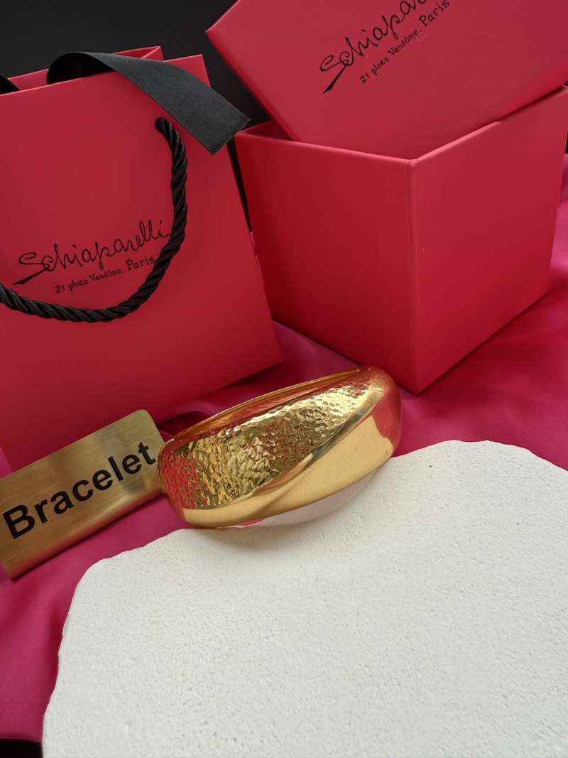 Золотистый браслет Schiaparelli