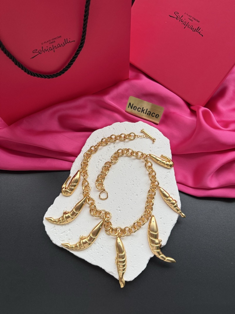 Золотистое колье с декоративными элементами Schiaparelli