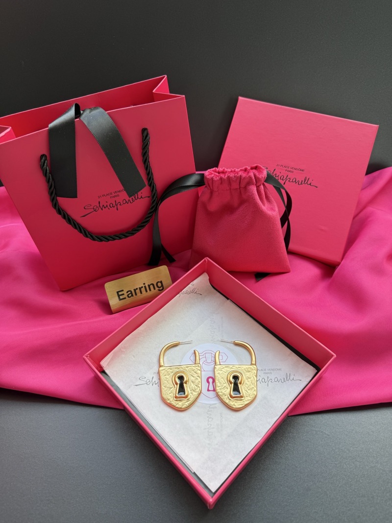 Золотистые серьги в форме замков Schiaparelli