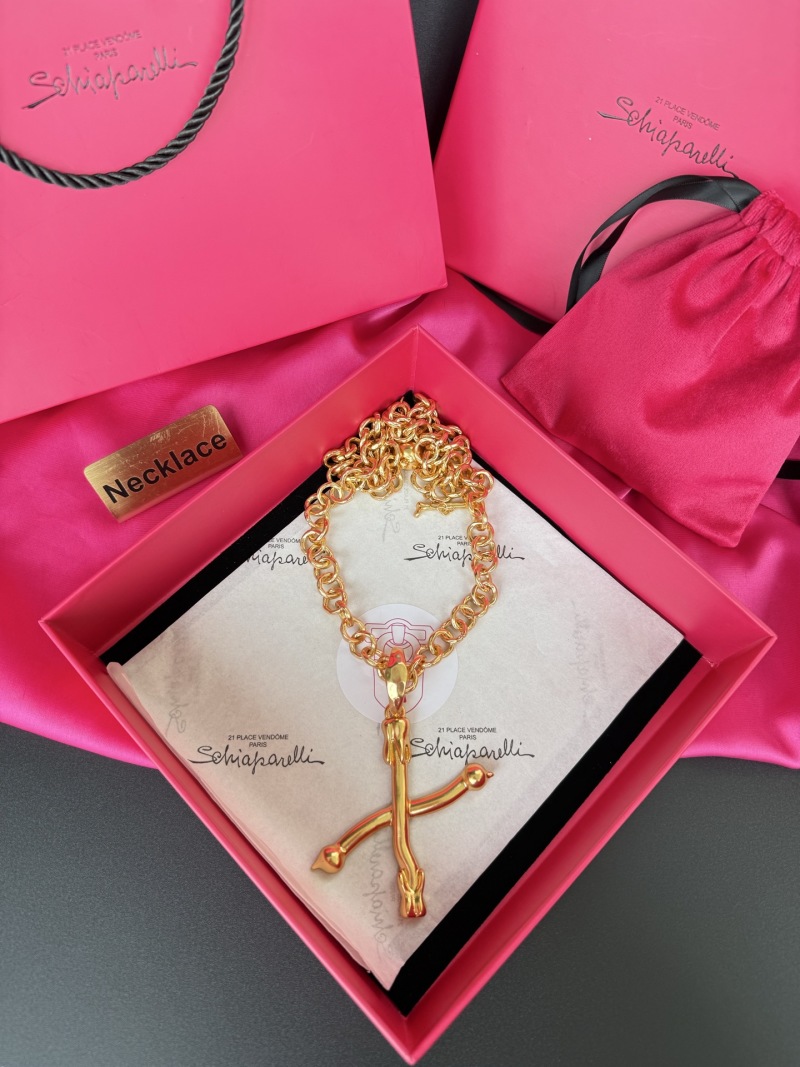 Золотистое колье с крестом Schiaparelli